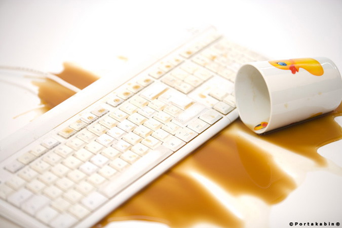 coffee cup spilled over computer keyboard. Conceptual Photography by David Barr