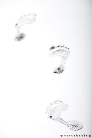black footprints on white floor. Conceptual Photography by David Barr